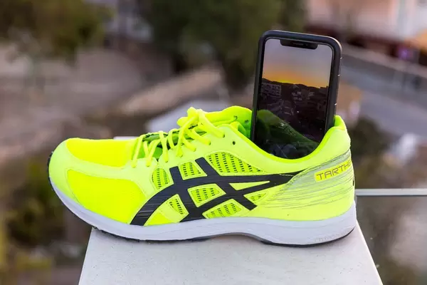 ASICS running shoe being used as a smartphone tripod