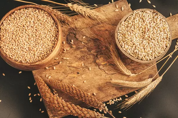 Assortment of assorted spikelets and grain in wooden bowls
