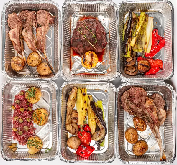 Assortment of delicious food in containers, top view