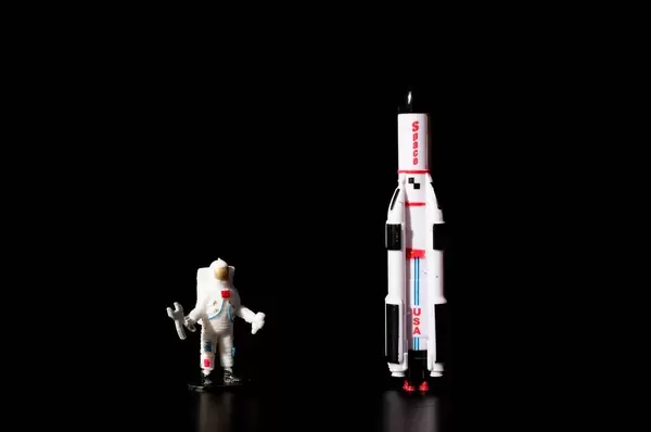 Astronaut and space ship on black background