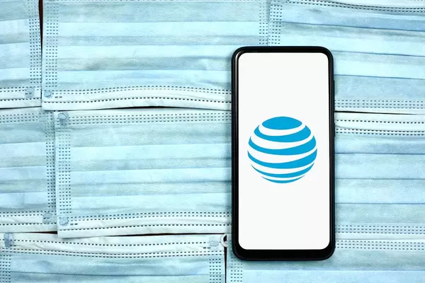 AT&T - Telecommunications company logo on mobile phone display. Coronavirus crisis changing global business rules
