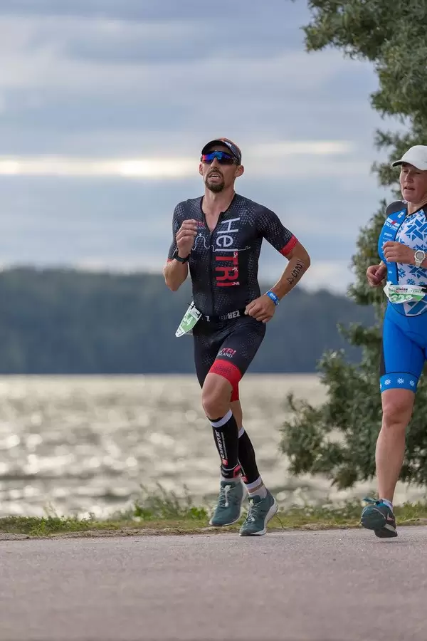 Athlete runs successfully the last meters of the half marathon before finishing the Ironman 70.3 in Lathi, Finland