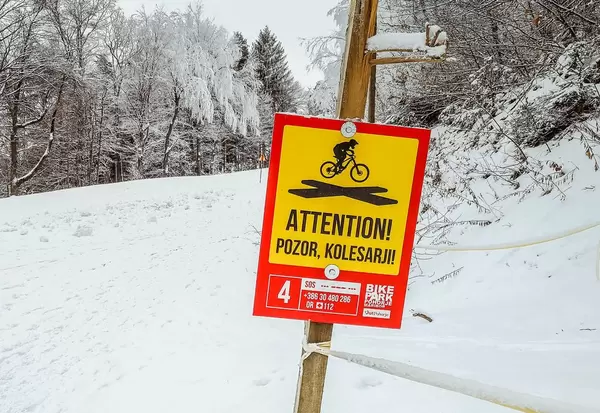 Attention sign at Bike park Pohorje in winter