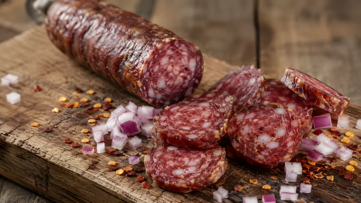 Aufgeschnittene Salami auf rustikalem Holzbrett