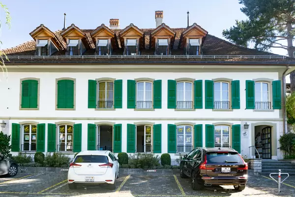 Authentic traditional Swiss building with green windows shutters