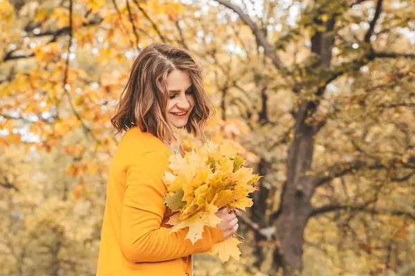 Autumn leaves in girl hands