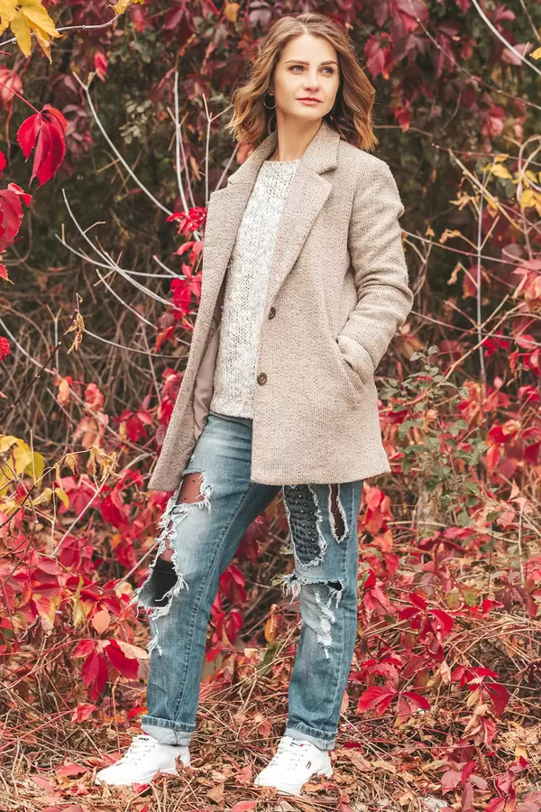 Autumn portrait of a girl with bright red leaves