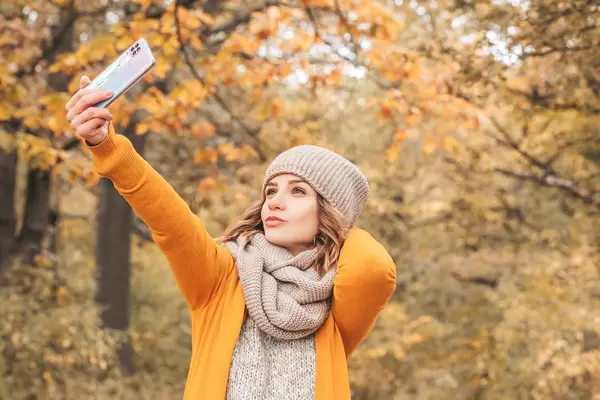 Autumn selfie, girl with smartphone