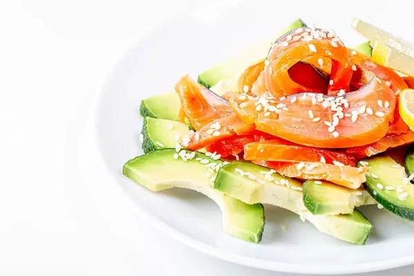 Avocado and smoked red fish salad on a white plate (Flip 2020)