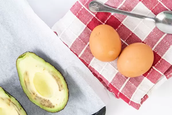 Avocado sliced on the half and chicken eggs (Flip 2019)
