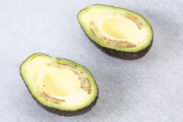 Avocado sliced on the half on the baking paper (Flip 2019)