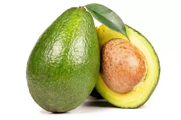 Avocado with a green leaf on a white background
