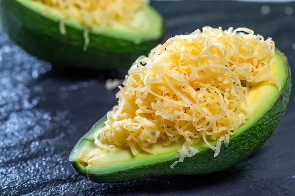 Avocado with cheese filling close-up