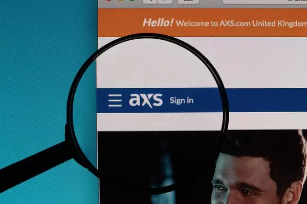 AXS.com logo under magnifying glass