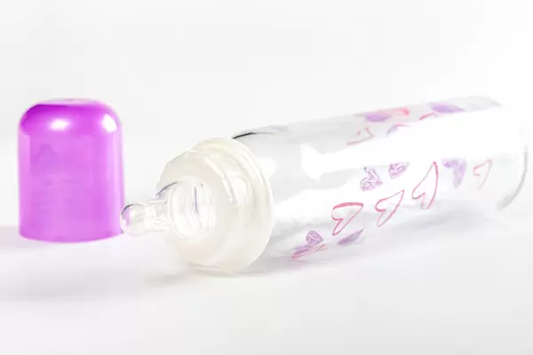 Baby bottle and pacifier on a white background