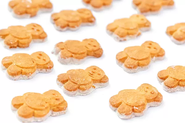 Baby cookies in the shape of bears on a white background