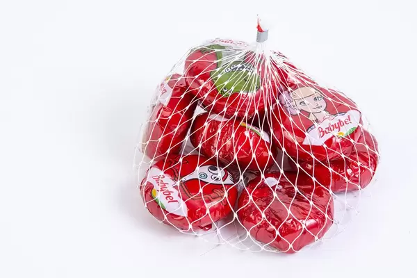 Babybel cheese in the bag above white background