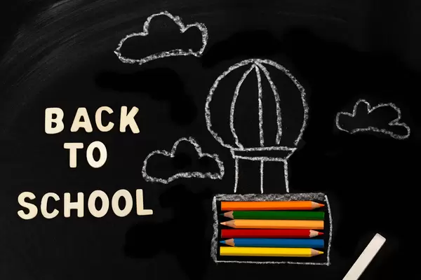 Back to school background with air balloon and pencils