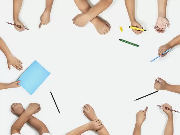 Back to school concept. Set of pupil hands. Top view