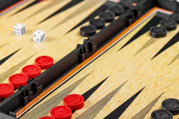 Backgammon board with black and red checkers and dice (Flip 2019)