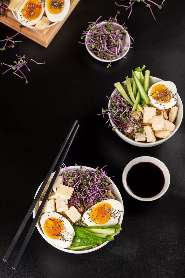 Background of bowls with healthy food on black