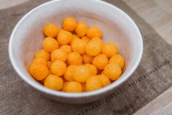 Background Of Extruded Puff Cheese Balls From Above (Flip 2020)