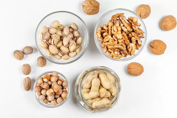 Background with different types of nuts in the skin and without (Flip 2020)
