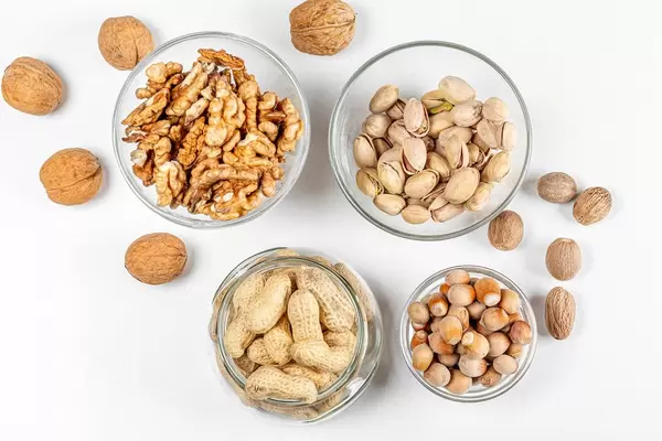 Background with different types of nuts in the skin and without