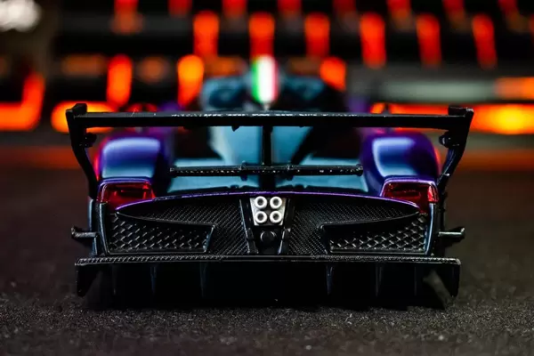 Backside of a mini sports car on black surface (Flip 2019)