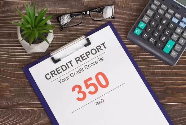 Bad credit score report of 350 on wooden table