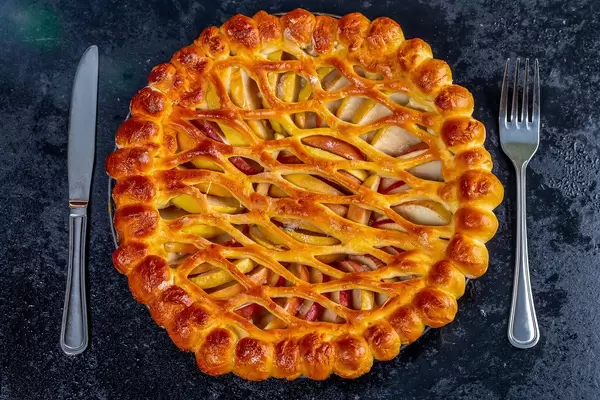 Baked Apple pie with knife and fork. Top view (Flip 2019)