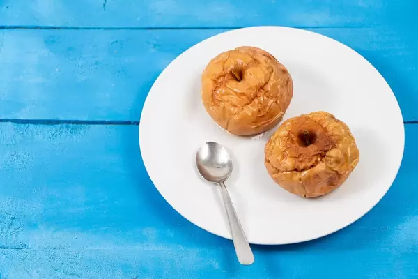 Baked Apples with spoon on the plate