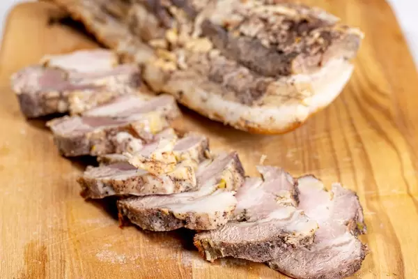 Baked bacon on a wooden kitchen Board