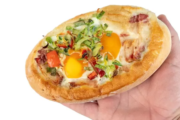 Baked Bread with Eggs and Onions on the hand (Flip 2019)
