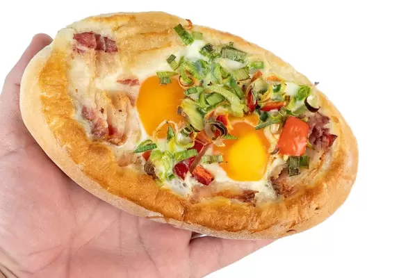 Baked Bread with Eggs and Onions on the hand
