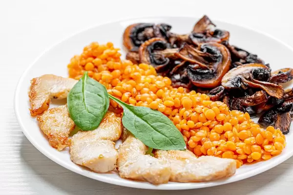 Baked chicken fillet with mushrooms and lentils