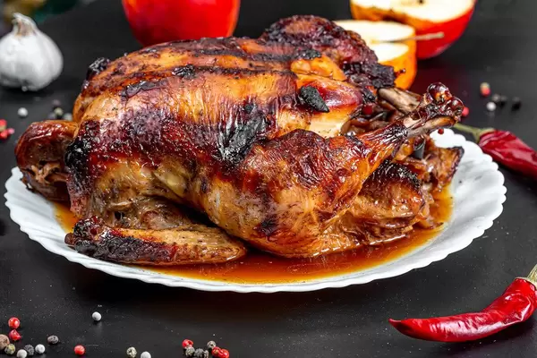 Baked chicken stuffed with apples with spices, chili and fresh apples