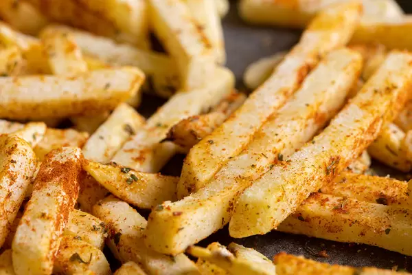 Baked French Fries with chilly spices served on the baking tray