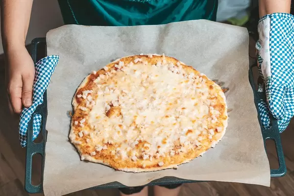 Baked homemade pizza with smoked chicken and mozzarella