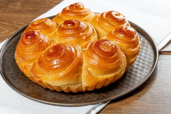 Baked homemade salty buns with garlic on a baking sheet (Flip 2019)