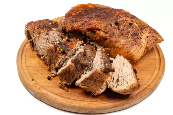 Baked meat on a wooden cutting board