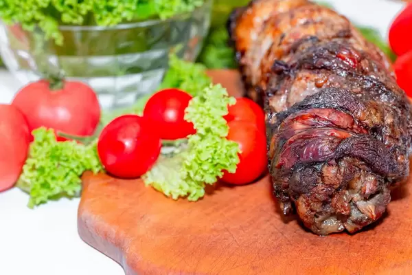 Baked meat with tomatoes and lettuce  Flip 2019