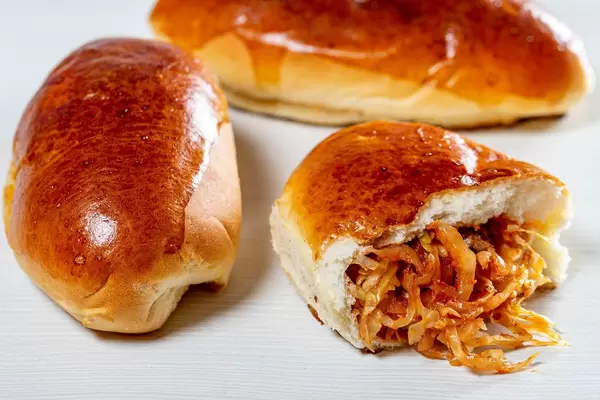 Baked pies with cabbage on a light background (Flip 2019)