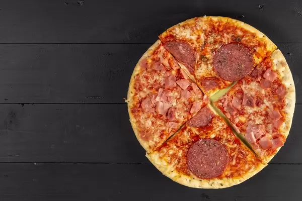 Baked Pizza with Sausage on the black wooden table