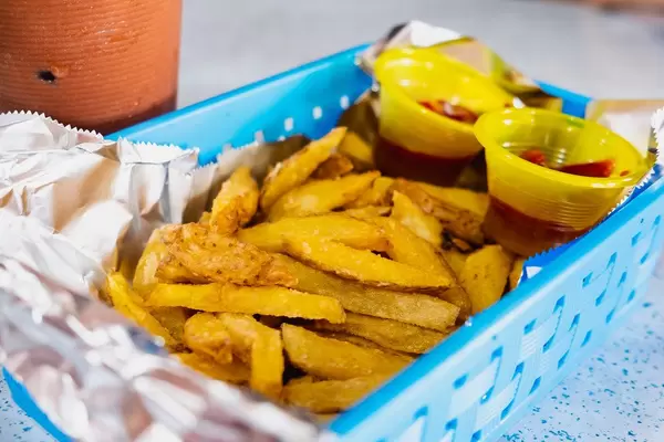 Baked potato strips served with ketchup