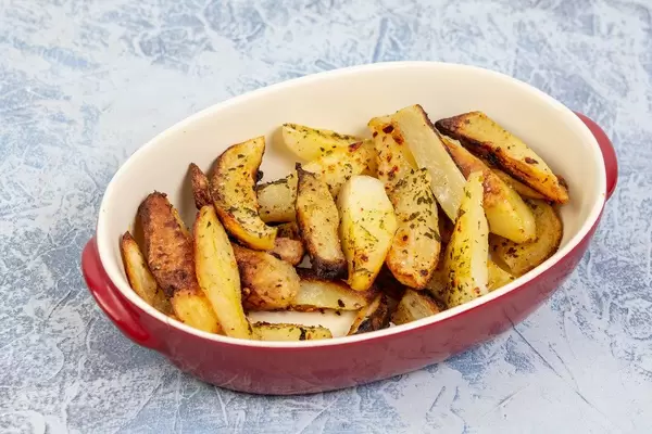 Baked Potatoes served in the bowl on the table
