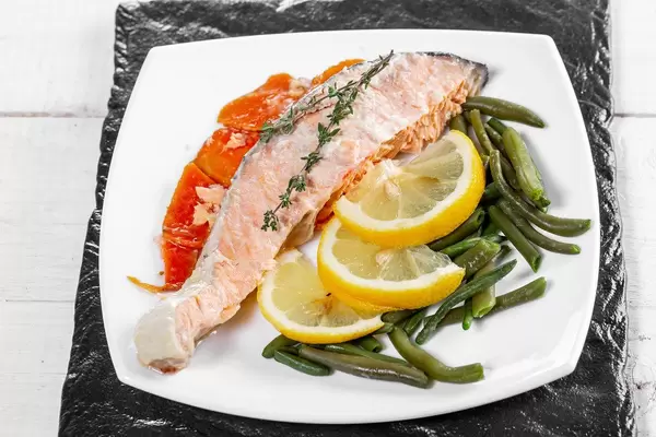 Baked salmon garnished with asparagus and carrot with herbs (Flip 2019)