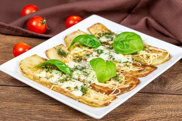 Baked zucchini with cheese and herbs