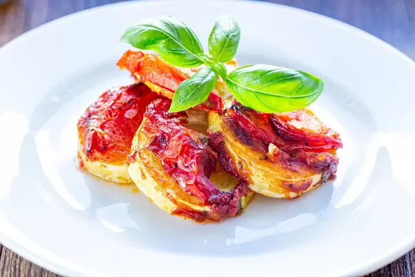 Baked zucchini with tomatoes and Basil