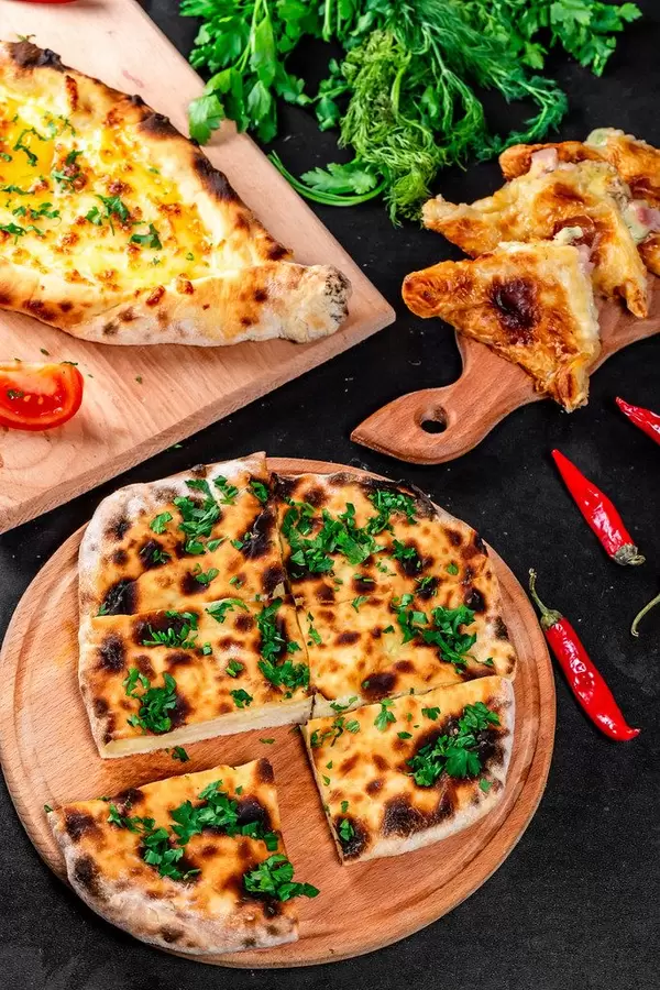 Baking background with three kinds of khachapuri - meat, cheese and Adygei khachapuri